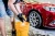worker-washing-red-car-with-sponge-car-wash (1).webp